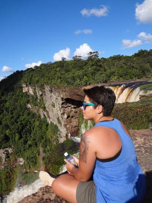 Al sitting by a waterfall in Guyana