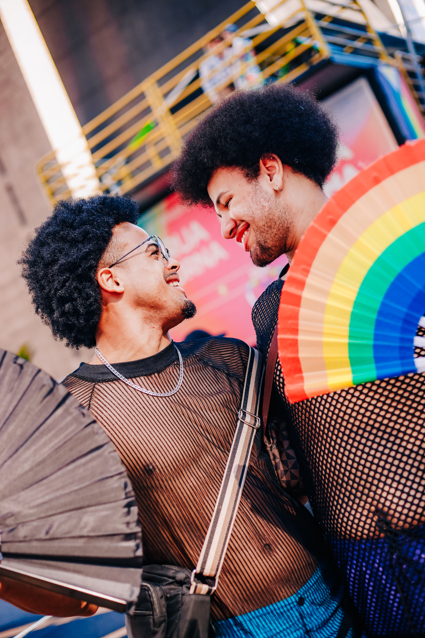 Two Black people with natural hair and big smiles