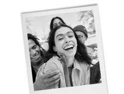 polaroid of a laughing happy Latinx trans person with friends