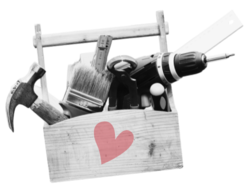 Wooden toolbox with tools inside and a heart on top