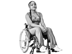 a young Black woman in a corset top and athletic pants in a wheelchair