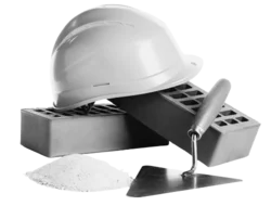 A hardhat with bricks and a trowel