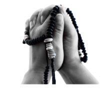 a pair of brown hands in a prayer with beads