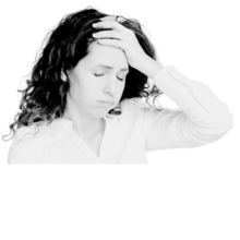 A woman with long, curly hair holds her hand against her forehead. She looks stressed and is breathing out heavily.